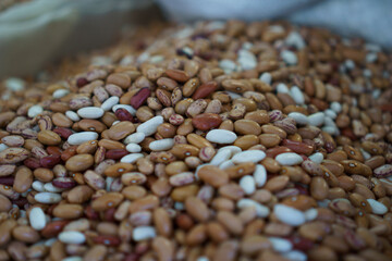 A close-up of a bag of brown and white beans.