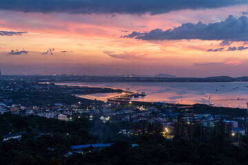 Beautiful sunset landscape view of fisherman village, light trail and bridge at Bang Sai district, Chonburi, Thailand