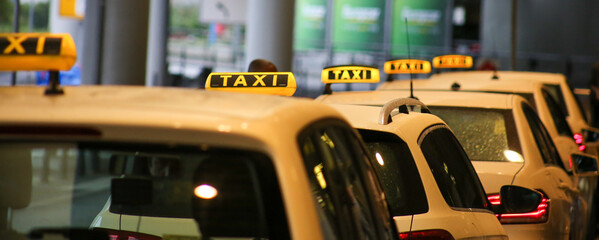 Taxi sign on yellow cab on rainy day