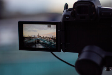 Fototapeta na wymiar Camera recording the Millennium Bridge ramp and St Paul Cathedral