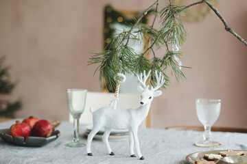 Festive Christmas home. Table setting with rustic decorations for Christmas. New Year decorations in modern interior design. 