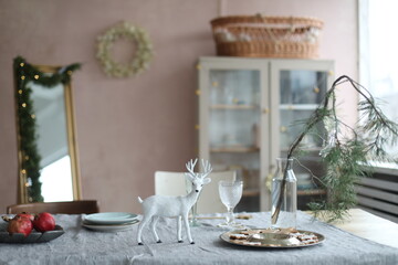 Festive Christmas home. Table setting with rustic decorations for Christmas. New Year decorations in modern interior design. 