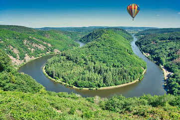 hot air balloon over a bend in the river Saar, also known as Saarschleife near the German city of...