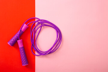 Minimalism fitness concept. Skipping rope on color background.