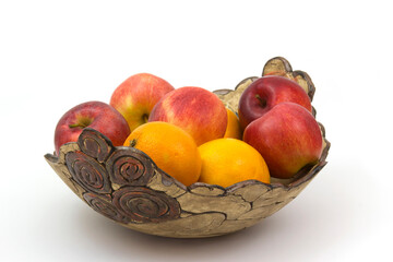 fresh fruits in a clay bowl - oranges and apples