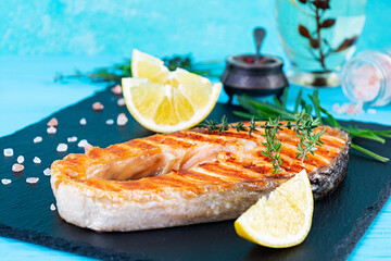 Grilled salmon fish on stone board. Salt atlantic salmon fried on grill with lemon