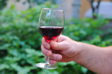glass of red wine in hand