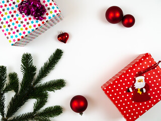 Christmas composition. Gift boxes, christmas decoration and fir tree branches on white background. Flat lay, top view.