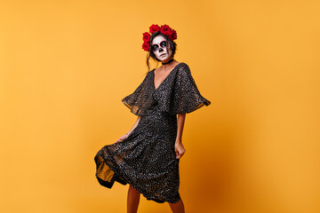 Light chiffon dress in polka dots scatters with every movement of amazing Latin woman in scary...