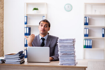 Naklejka premium Young male employee unhappy with excessive work
