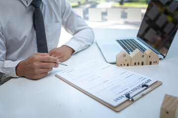 Real Estate agent with customer making contract sign on document for buy house contract, rent a house,get insurance or loan real estate or property.