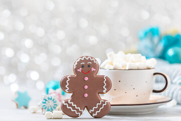 Homemade christmas gingerbread man cookies and cup of hot chocolate with marshmallow.Traditional Christmas food.