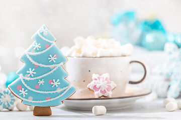 Hot winter drink. Cup of hot chocolate with marshmallows and gingerbread cookies on white background.