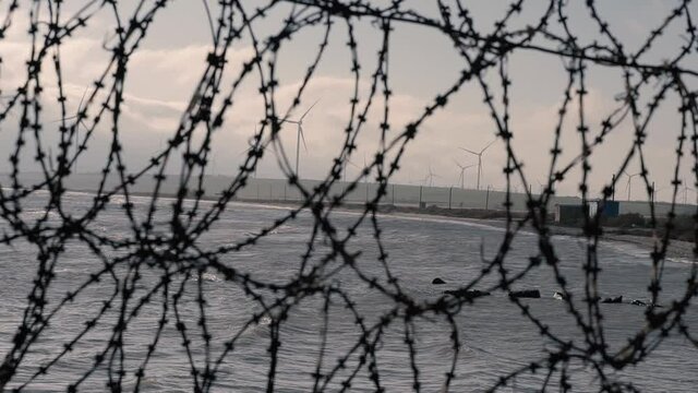 Barbed wire. Barbed wire fence near the sea.