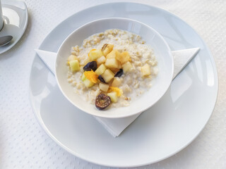 Oatmeal with fresh berries and fruits in a bowl on top. Healthy lifestyle, healthy eating, diet, fitness and vegetarian food concept