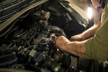 mechanic repairing the engine of a car