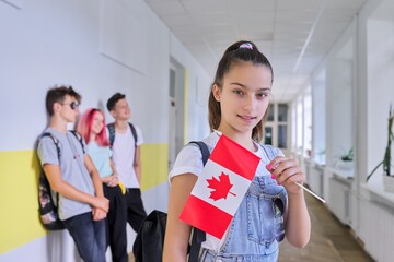 Student teenager female with flag of Canada inside school