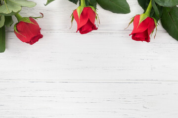 Red rose background for Valentines day, Mothers day, Birthday card. Flowers on the wooden table flat lay