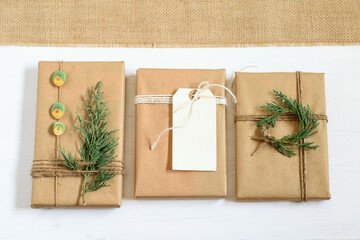 Gift boxes wrapped in craft eco friendly paper, festively decorated. Nice zero waste mock up design...