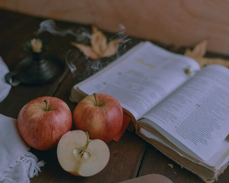 
Ripe red apples with bible or book Autumn background of leaves, fruits and vegetables. Fall season, eco food and harvest concept.

Red Braeburn apples on rustic wooden surface.