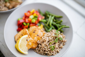 Salmon and buckwheat dish with green beans and tomato