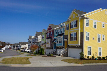 Neighborhood street lined with multicolored townhouses