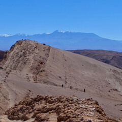 Hiker on lonely trail on dune in valley of the moon, Atacama salt desert, Chile