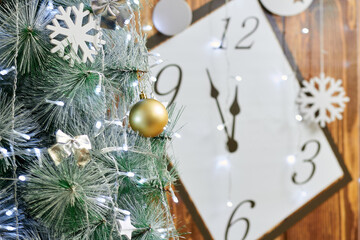 Christmas background with clock, snow fir tree and gift boxes over wood