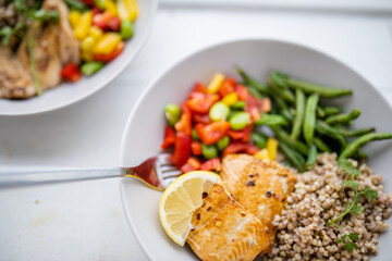 Salmon and buckwheat dish with green beans and tomato