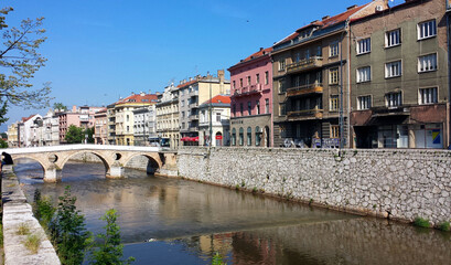 Obraz premium Sarajevo, Bosnia and Herzegovina - June 25, 2017: Latin Bridge and the houses on the river in Sarajevo.