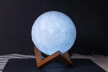 moon shaped night light glows in the dark. decor for the home. selective focus