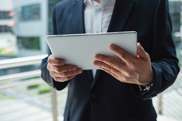 Unrecognizable business man using digital tablet in business district