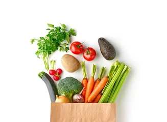 Tuinposter Paper grocery bag full of healthy vegetables top view isolated on white background © Karlis