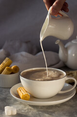 milk, milkman, tea, coffee, waffles, sweet, tea steam, pours, drops, splashes, cup, drink, breakfast, food, hot, white, beverage, cafe, spoon, brown, espresso, morning, table, caffeine, cream, bowl, s