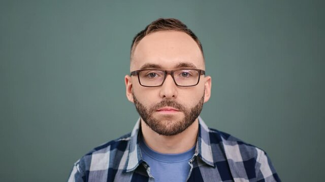 Closeup portrait of confident bearded male in glasses posing. Shot on RED Raven 4k Cinema Camera