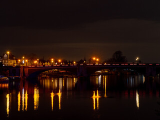 Fototapeta na wymiar Bridge over water in the night, long exposure 