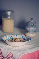 Breakfast at home oatmeal with nuts and honey on a white tablecloth