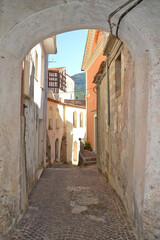 Fototapeta na wymiar A narrow street with among the old houses of Rivello, a medieval village in the Basilicata region.