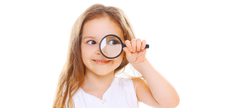 Cute Child Looking Through Magnifying Glass Isolated On A White Background