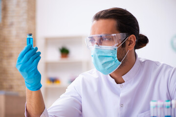 Young male chemist working in the lab