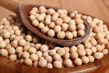 Whole yellow peas in wooden bowl