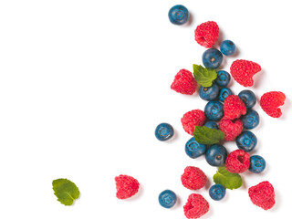 Various fresh summer berries background with copy space for text.Creative layout of fresh blueberries, raspberries and mint leaves, isolated on white background with clipping path.Top view or flat lay