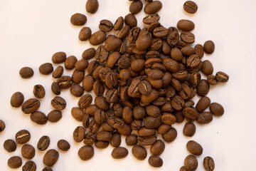 Brown, roasted coffee beans thrown in the middle