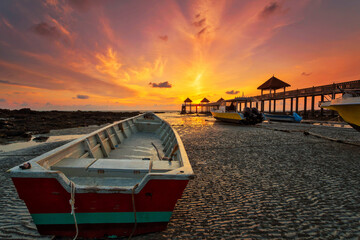 Fototapeta na wymiar A long exposure picture of majestic sunrise with a jetty as a background at Tanjung Balau, Johore