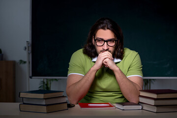 Young male student preparing for exams in the classroom