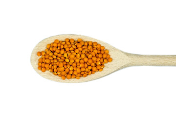 Red lentils on wooden spoon isolated on white background top view