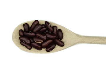 Dried kidney beans on wooden spoon isolated on a white background