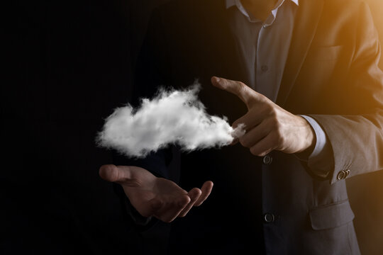 Businessman man hand holding cloud.Cloud computing concept, close up of young business man with cloud over his hand.The concept of cloud service. © Ivan