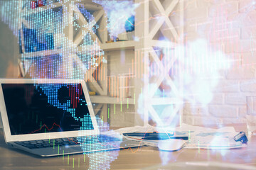 Financial chart drawing and table with computer on background. Multi exposure. Concept of...