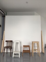 a variety of studio equipment for a photo studio, decor items for work for photographers, vintage furniture for a photo studio, a variety of wooden chairs stools